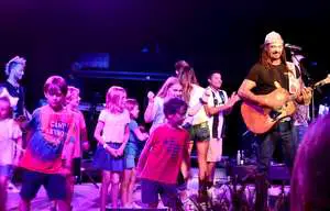 Kids on stage with Michael Franti