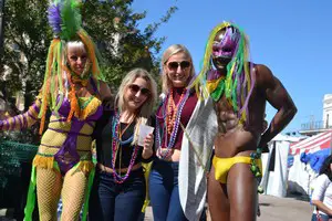 girls and boys at Mardi Gras wearing their beads