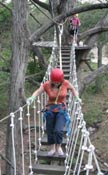Up the swing rope bridge to one of the platforms at Cypress Valley Canopy Tours